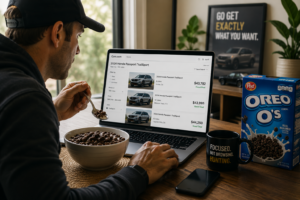 A shopper eats a bowl of Oreo O's cereal while comparing vehicle listings online, illustrating the focused search behavior of high-intent automotive buyers looking for a specific vehicle.